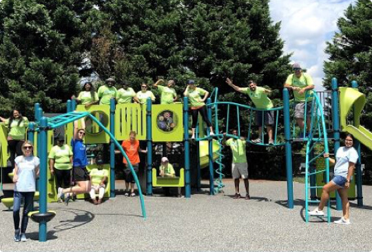 Group of people on and around a playground.